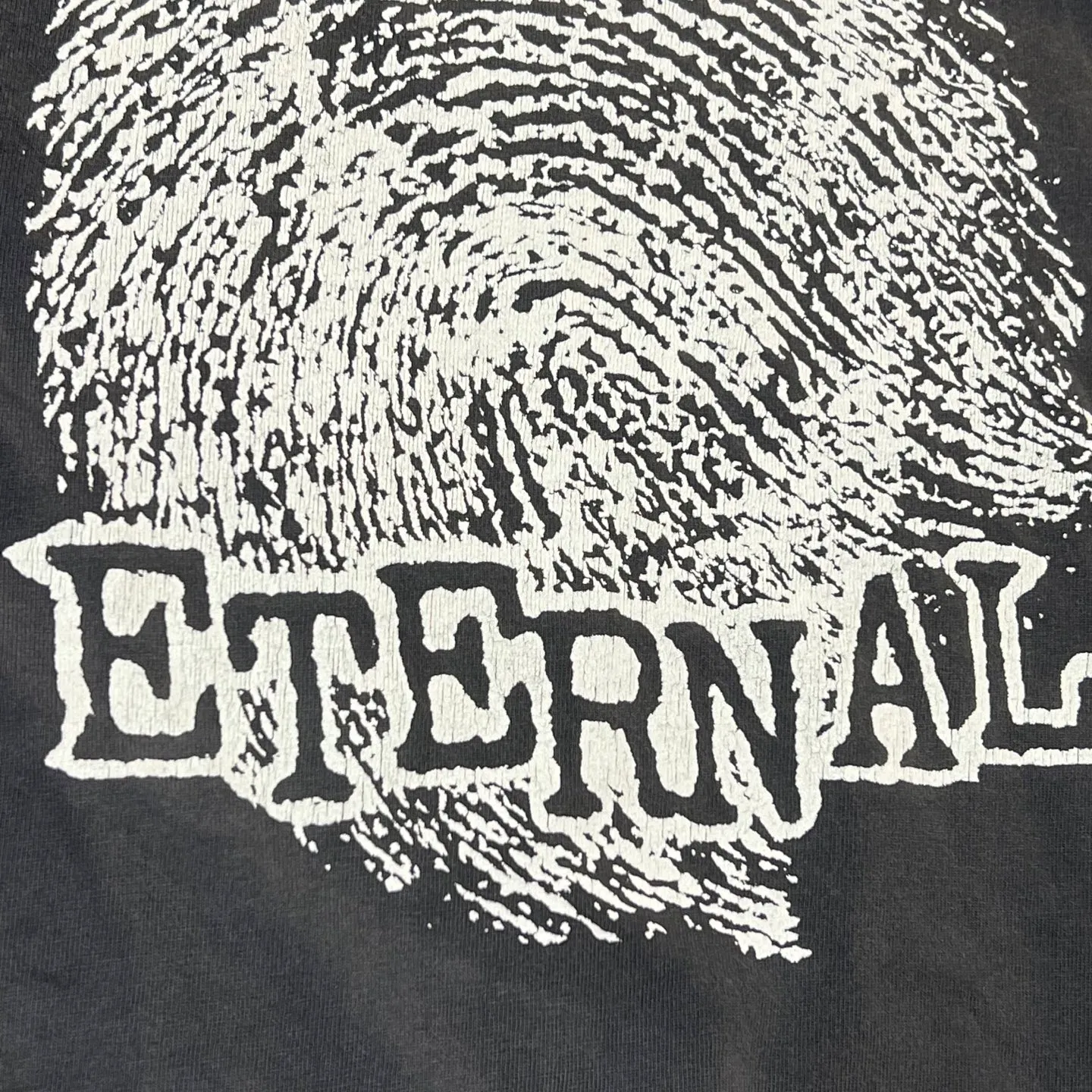 SAINT Mxxxxxx CHOSEN SS TEE/BLK Burst pattern/fingerprint print Chosen Tee Washed black S-XL Look for cylindrical fabrics without side seams. Don’t buy open-width fabrics anymore. It’s boring. Assute garment dyeing. Spray the whole piece with Ma Liu. Re-spray heavy fade. Collar and cuffs are frayed. Many places are broken. Authentic grade printing restored. Original consistent main mark/wash mark/with little angel anti-counterfeiting label.